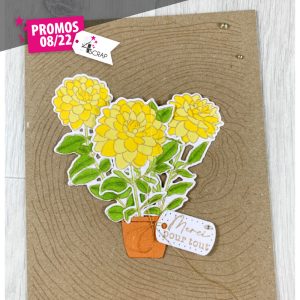 Carte de scrapbooking avec des fleurs dahlia et un fond bois.